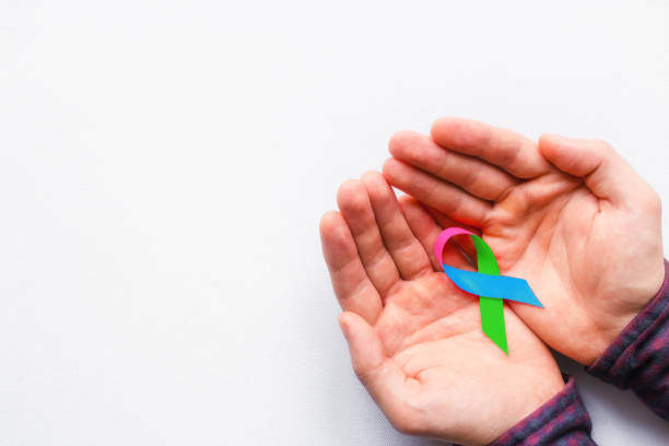 Hands holding a rare disease awareness ribbon